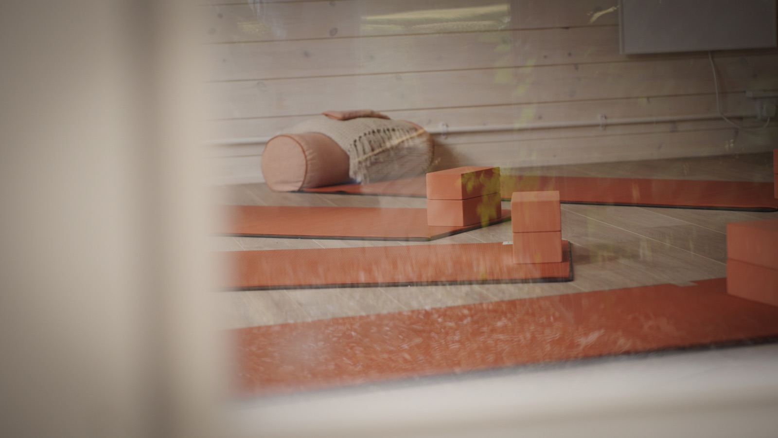 Yoga blocks and mats in soft focus